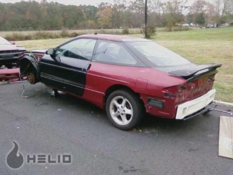 1993 Ford Probe - This 1993 Ford Probe is missing its front fender and bumper, revealing its mechanical components.