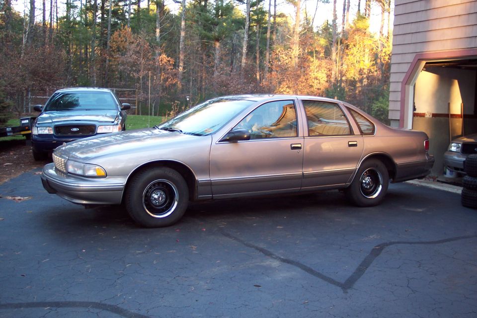 1990s Chevrolet Caprice sedan parked next to a Ford Crown Victoria