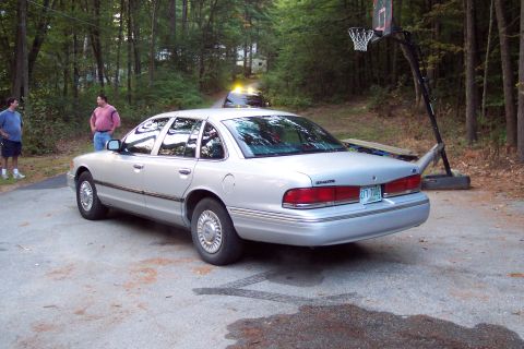 2001 Ford Crown Victoria - Silver 2001 Ford Crown Victoria parked on a driveway with a basketball hoop in the background.