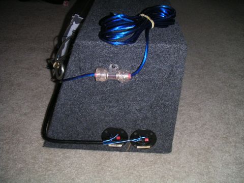 1994 Ford Bronco - A car audio subwoofer box is shown with its wiring and fuse holder connected.
