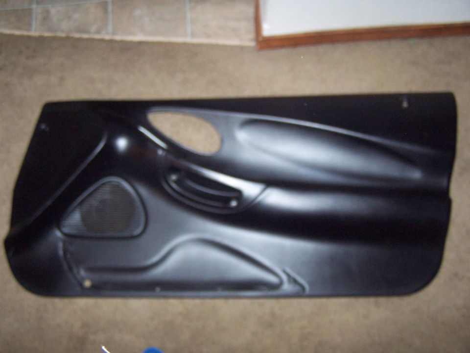 Black car door panel with speaker grille