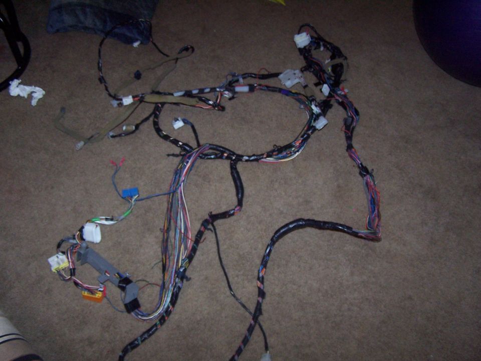 Car wiring harness laid out on a carpeted floor
