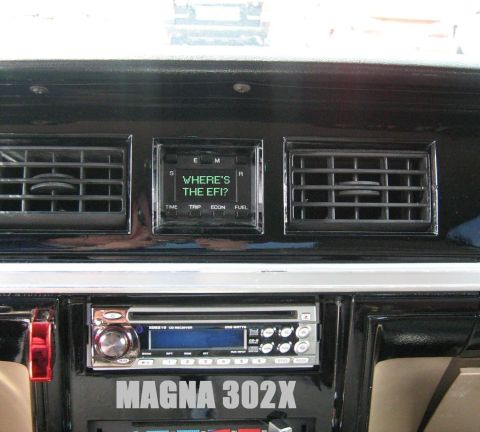 1988 Mercury Grand Marquis - Interior view of a car dashboard, showing the central console with a digital display and stereo.