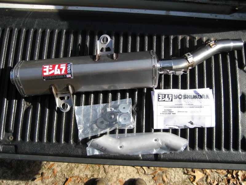 Yoshimura RS-3 exhaust for Suzuki King Quad 700 with hardware and instructions on truck bedliner