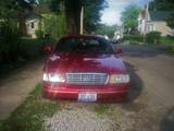 2000 Ford Crown Victoria - Front view of a red 2000 Ford Crown Victoria parked on a residential street.