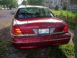 2000 Ford Crown Victoria - Rear view of a red 2000 Ford Crown Victoria sedan parked outdoors.