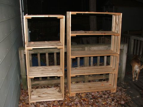 1996 Ford Bronco - Two wooden shelving units are positioned on an outdoor deck, with fallen leaves scattered around their bases.
