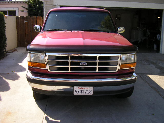 Red Ford F-Series truck front view, California license plate 5XQS718