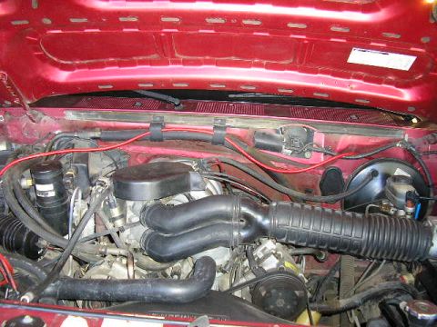 1994 Ford Bronco - A close-up view of the engine compartment, showing various hoses and mechanical parts under the hood.