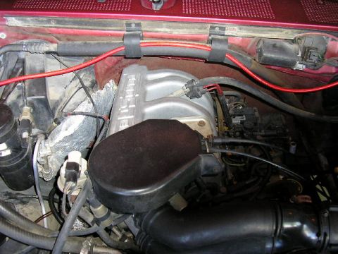 1994 Ford Bronco - Close-up view of an engine bay, showing the intake manifold and various hoses and wires.