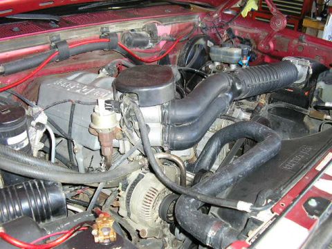1994 Ford Bronco - Close-up view of an engine bay, showing various mechanical parts and wiring.