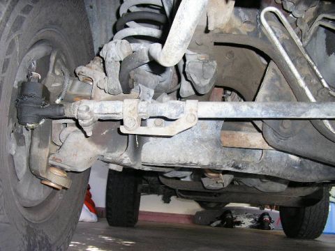 1994 Ford Bronco - Undercarriage view of a vehicle's suspension system, focusing on steering and suspension linkages.