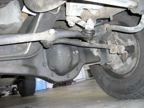 1994 Ford Bronco - Close-up view of the front axle and suspension system of a vehicle.