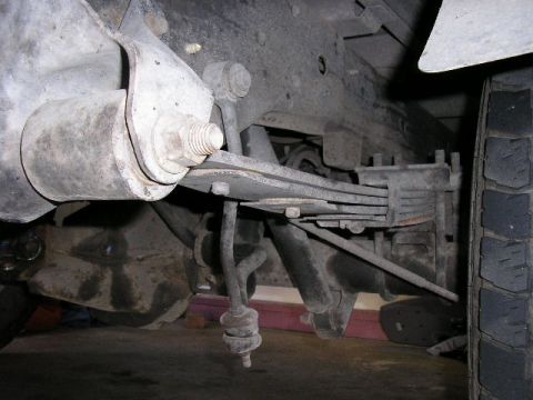 1994 Ford Bronco - Close-up of a vehicle's rear leaf spring suspension system.