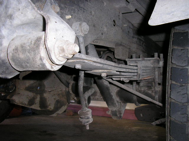 Rear leaf spring suspension with shock absorber and tire visible