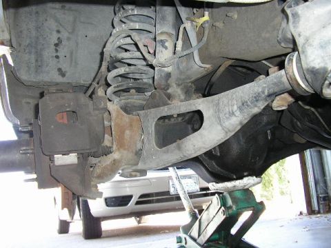 1994 Ford Bronco - Close-up view of a vehicle's rear suspension and differential assembly.
