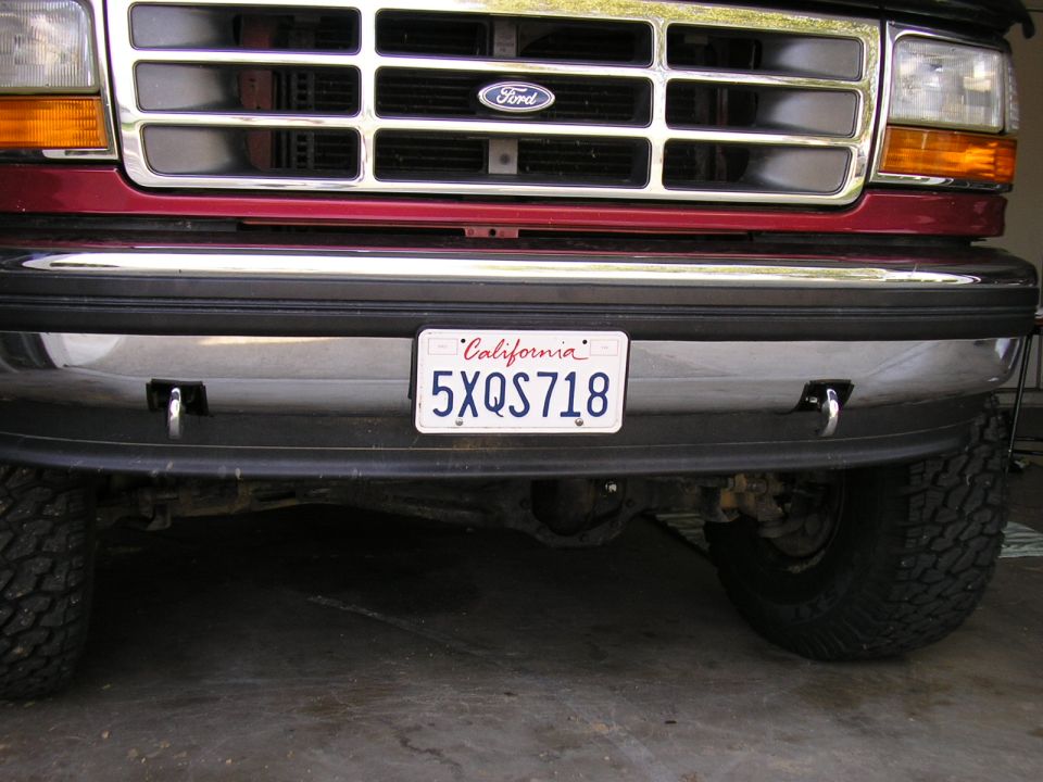 1994 Ford Bronco front bumper with California license plate 5XQS718 and two visible tow hooks