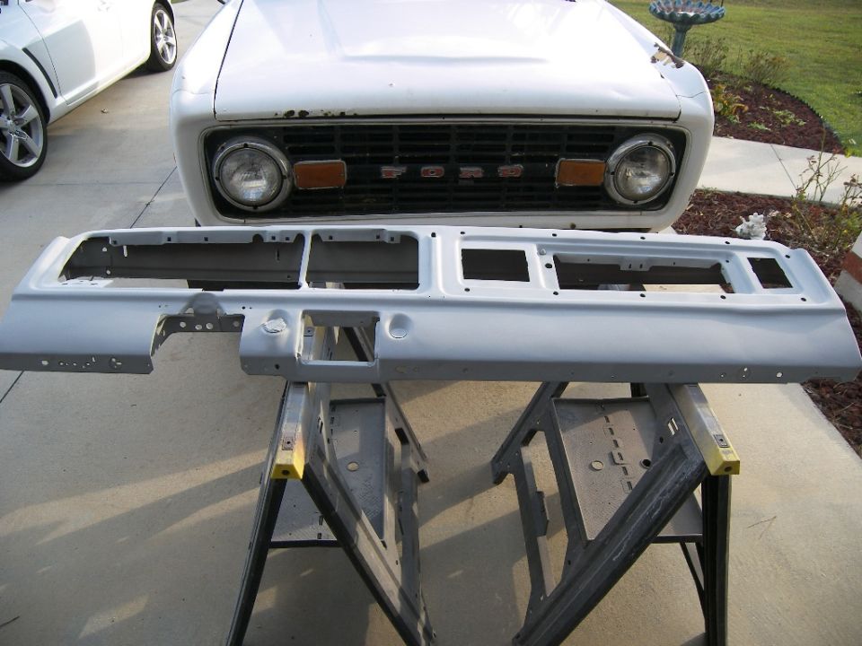 White 1978 Ford Bronco front end with a removed dashboard sitting on sawhorses in front of it