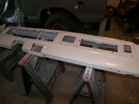1978 Ford Bronco - A white dashboard panel, likely for a classic vehicle, is disassembled and supported by sawhorses.