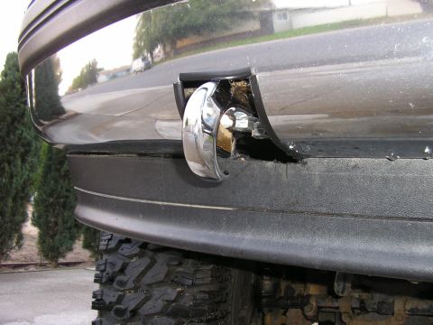 1994 Ford Bronco - Close-up of a chrome tow hook installed on the front bumper of a 1994 Ford Bronco.