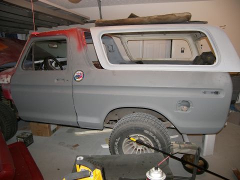 1978 Ford Bronco - A 1978 Ford Bronco is seen in a garage, appearing to be in the process of body repair and painting.