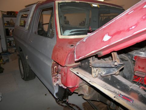 1978 Ford Bronco - This SUV is undergoing bodywork, with the hood open and various panels showing primer and unfinished paint.