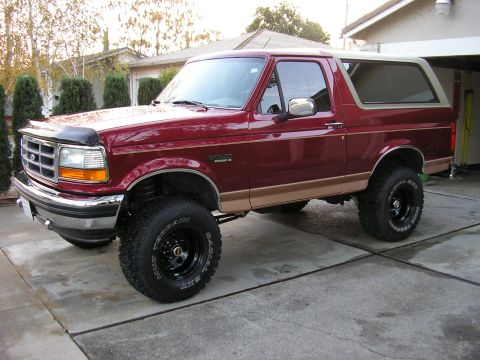 1994 Ford Bronco - This maroon Ford Bronco features a tan two-tone paint scheme and appears to be a 1992 model year.
