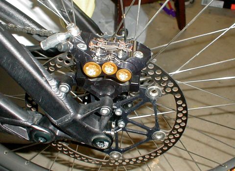 1996 Ford Bronco - Close-up view of a bicycle's rear disc brake caliper and rotor assembly.