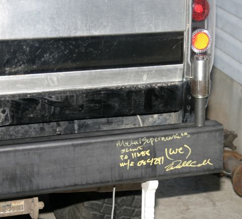 1994 Ford Bronco - A rear bumper displays handwritten text including company names and order details.