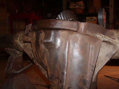 1991 Ford Bronco - Differential housing and gears shown in detail, supported by jack stands in a workshop setting.
