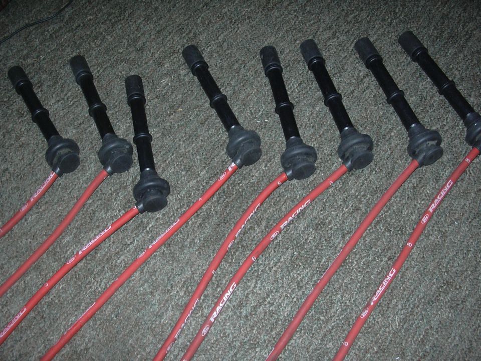 Red spark plug wires with black boots, labeled "Ford Racing"