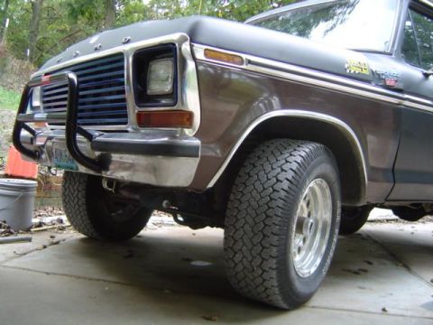 1979 Ford Bronco - The front end of a brown and black 1978 Ford Bronco is shown from a low angle.