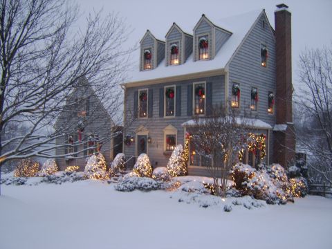 1996 Mercury Grand Marquis - A house covered in snow, adorned with Christmas wreaths and lights.