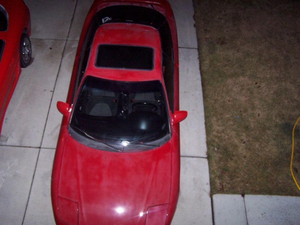 Red 1994 Ford Probe coupe with sunroof, seen from above
