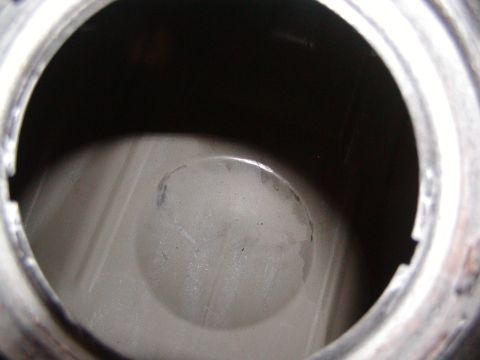 1991 Ford Bronco - Close-up view of the interior of a fuel pump assembly, showing a circular indentation and some wear marks.