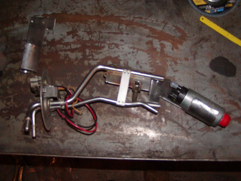 Fuel pump assembly with metal lines and red-capped end