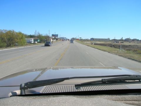 1996 Ford Bronco - View from inside a vehicle driving on a highway on a clear day.