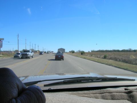 1996 Ford Bronco - Driving on a highway with traffic under a clear blue sky.