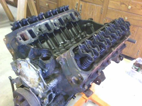 1979 Ford Ranchero - An engine block, likely from a V8, is shown with its valve covers removed, revealing the internal components.