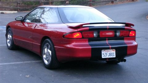1996 Ford Probe - Rear view of a red 1996 Ford Probe GT with black racing stripes and a spoiler.