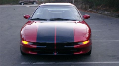 1996 Ford Probe - Front view of a red and black 1996 Ford Probe with racing stripes.