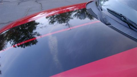 1996 Ford Probe - Close-up view of a car's hood and windshield, showing a red and black stripe design.