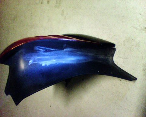 2000 Ford Crown Victoria - Automotive fender part with blue and red paint scheme.