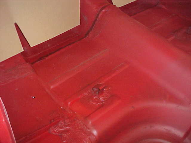 Red interior floor pan with visible structural details