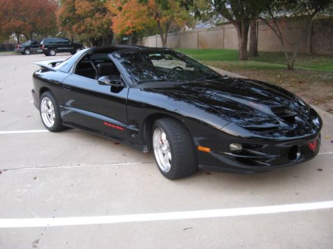 2002 Pontiac Trans Am - Black 2002 Pontiac Trans Am with red 'Trans Am' badging on the side.