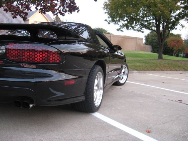 Black 2002 Pontiac Trans Am rear quarter view, parked in lot