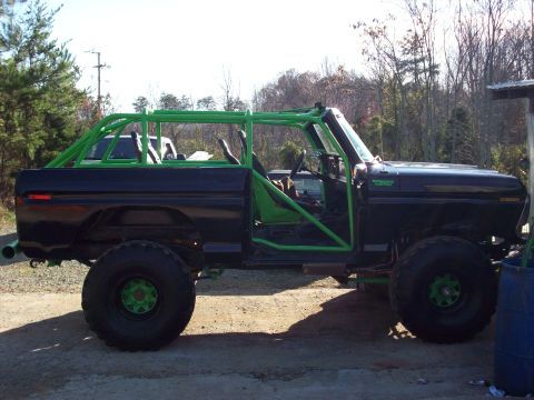 1978 Ford Bronco - Modified 1978 Ford Bronco features a full green roll cage and oversized tires.