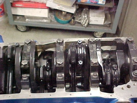 1968 Ford Mustang - Engine block with crankshaft and bearing caps. Some part numbers are visible on the caps.