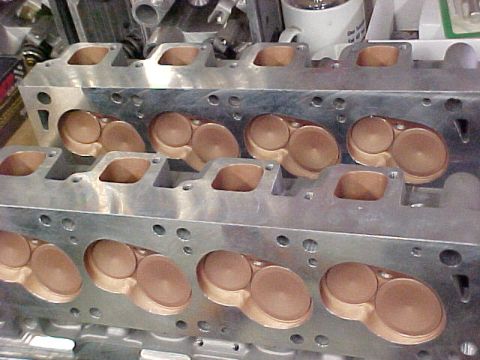 1968 Ford Mustang - Close-up view of two engine cylinder heads, showing intake and exhaust ports.