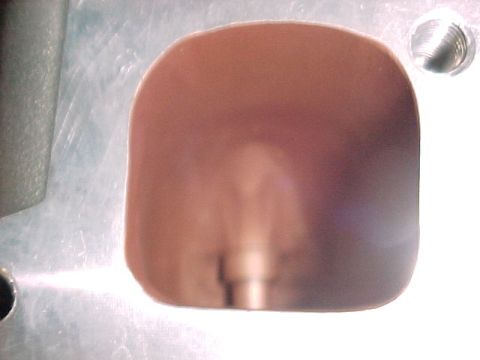 1968 Ford Mustang - A close-up view of a metallic component with a curved recess and a visible screw.